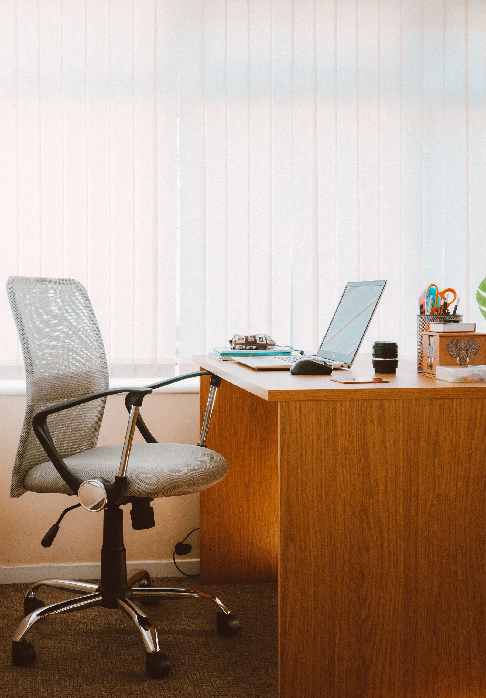 Ergonomic home office workstation with adjustable mesh chair and laptop at proper height