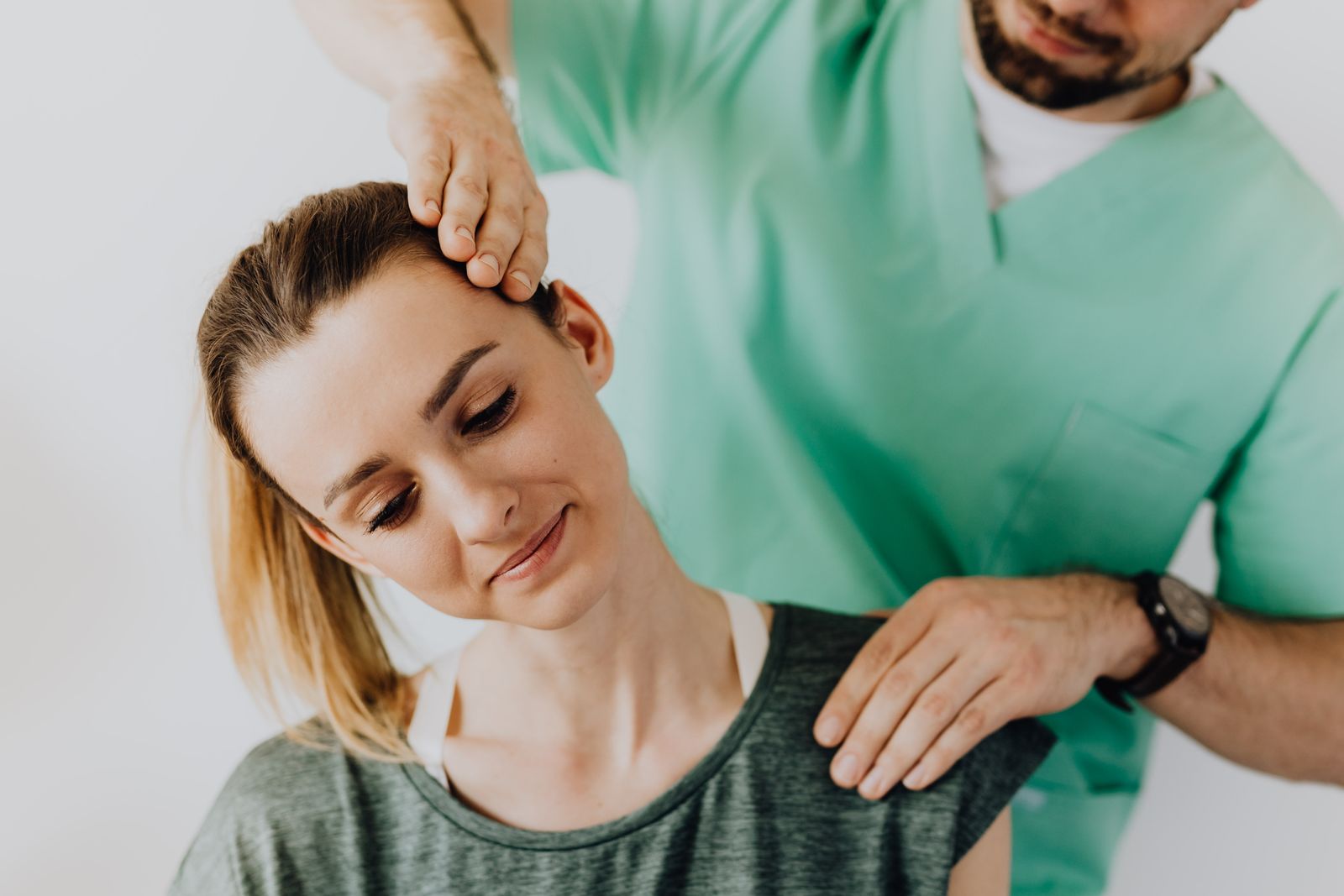 Chiropractor performing a gentle cervical neck mobilization on a patient recovering from an auto accident